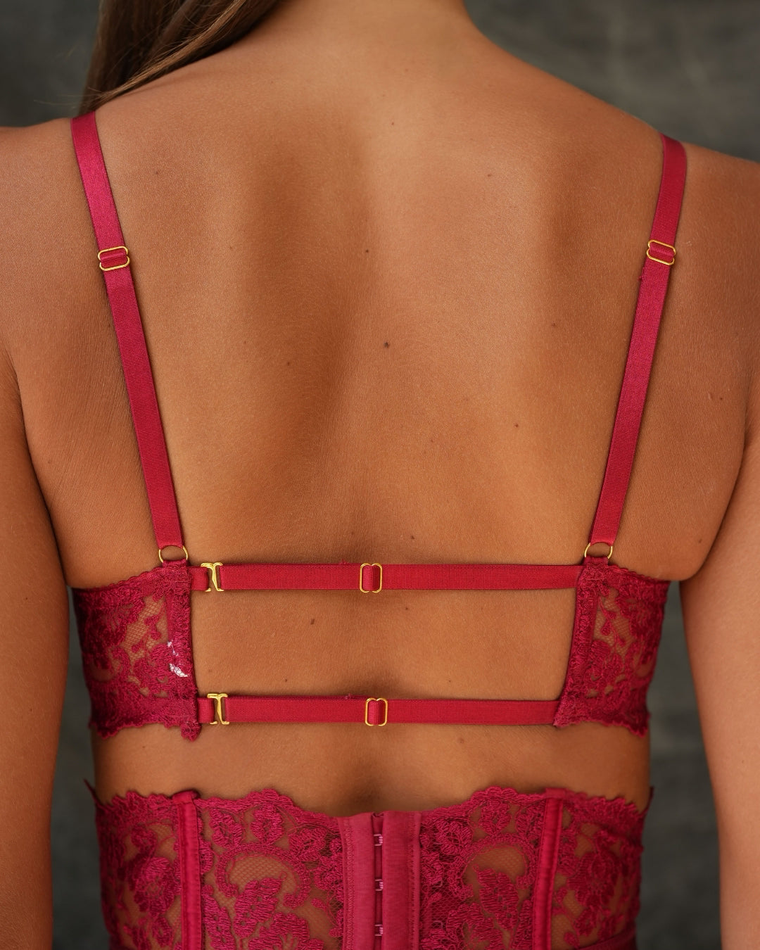 Red lace bra back strap detail with gold hardware